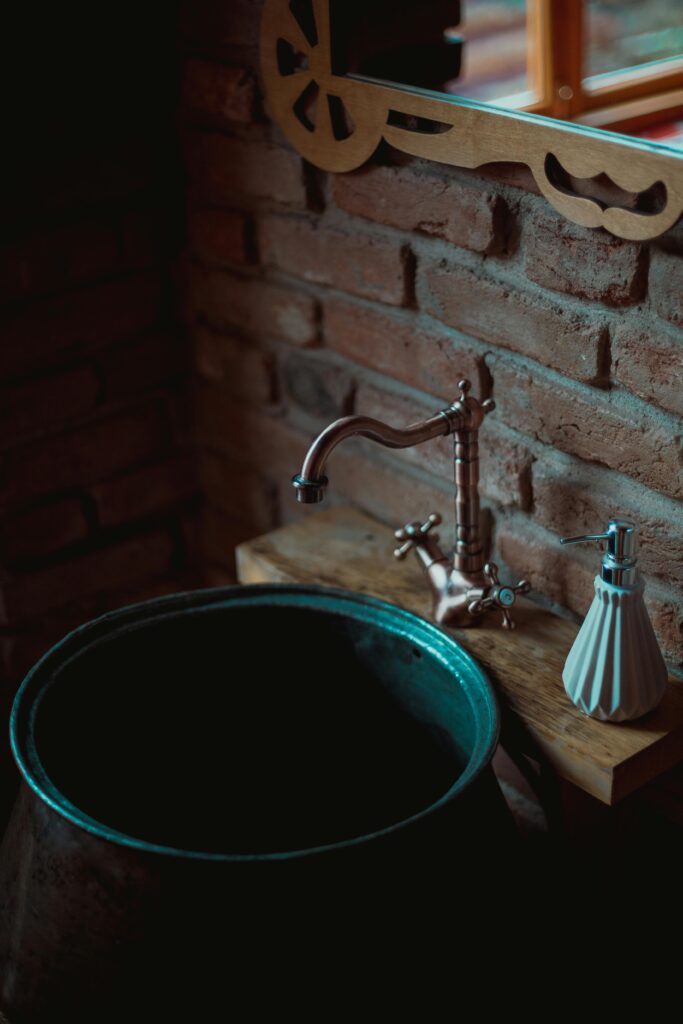 An ornate, dark wood antique bathroom vanity